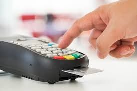 Eftpos machine, with someone puting in pin number. 