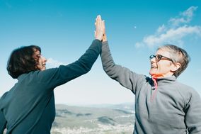 Two women giving each other a high five.